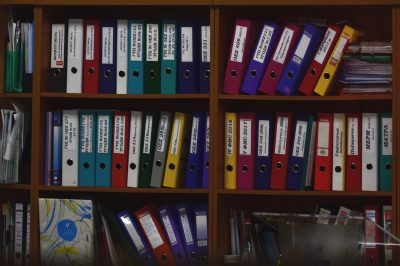 Different coloured document folders on a bookshelf